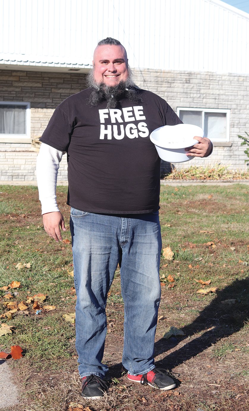Area resident Russ Fletcher welcomes voters to the 4-H Fairgrounds polling center on Election Day with free hugs and kisses. "No matter who wins tonight, tomorrow's gonna be a bad day for a lot of people. But if I can bring some sort of kindness and distraction from that, then it makes today all worth it for me," he said.